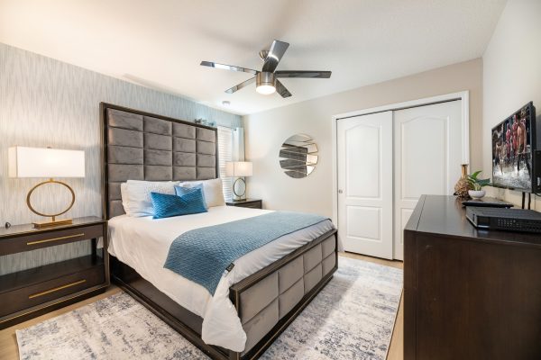 King bedroom with gray tufted headboard detail at Magic Moments Kissimmee vacation villa