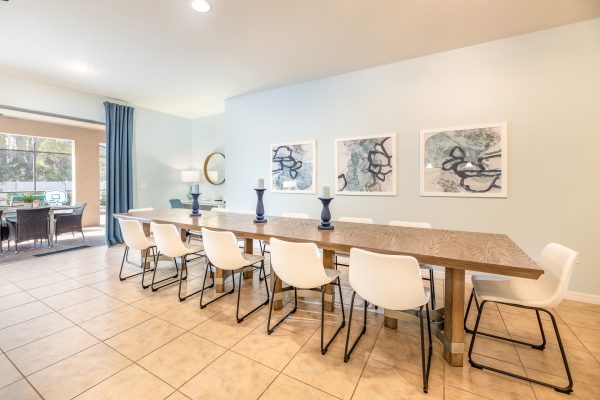 Spacious dining room with large table seating 12 guests at Magic Moments Kissimmee vacation villa