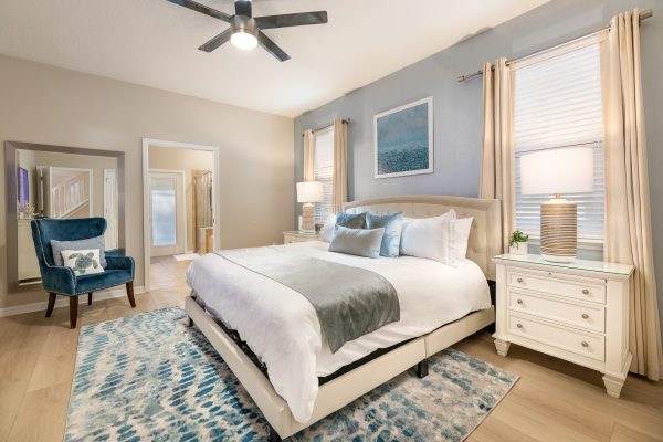 Master king bedroom with elegant blue decor at Magic Moments Kissimmee vacation villa