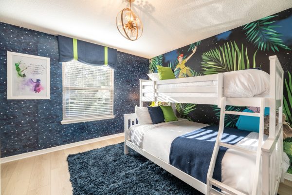 Peter Pan themed bunk room with white bunk beds and Neverland mural wall at Magic Moments Kissimmee vacation villa