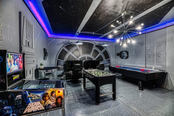 Star Wars themed game room with foosball and pinball machines at Magic Moments Kissimmee vacation villa